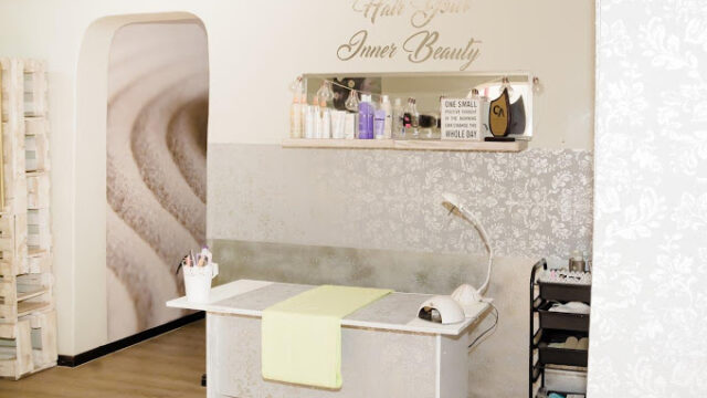 This picture shows the interior of the Hair Your Inner Beauty Hair Salon in Langebaan. Colour scheme is old soft white with table, accessories and wall paper