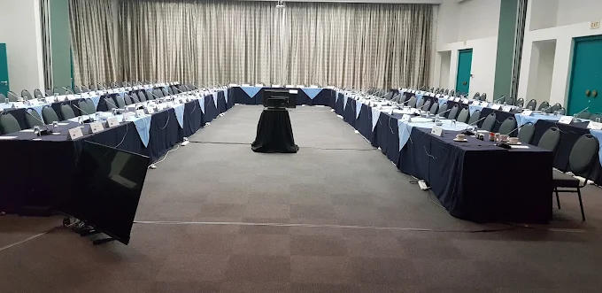 The interior of the Athene Conference centre in Langebaan showing conference facilities with tables, chairs, all spaced with dark table cloths
