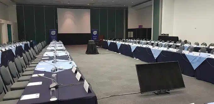 Conference facilities at Athene Conference Centre in Langebaan with blue and white linen and big Screen of presentations.