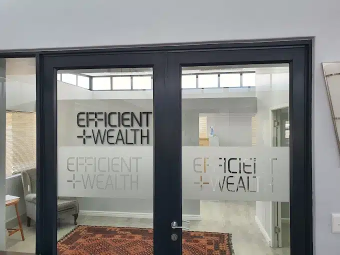 The entrance to the offices of Efficient Wealth in Langbeaan with glass doors and name on the glass doors.
