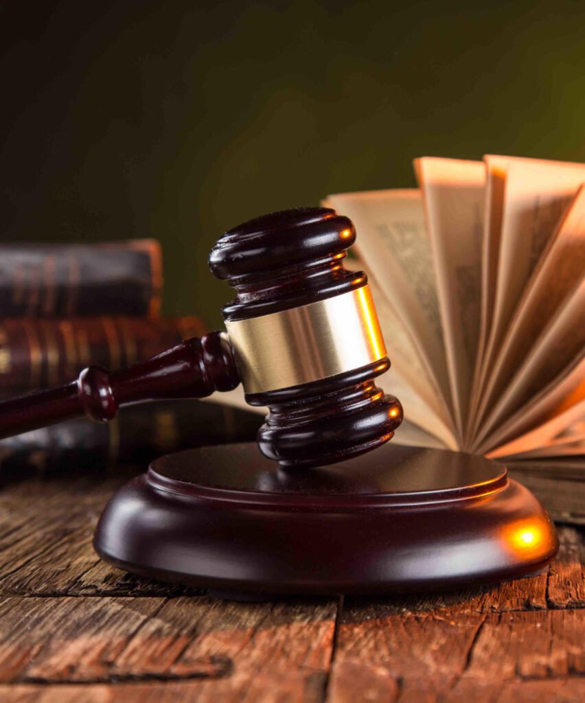 A wooden legal hammer and a book that reflect the law and justice by Geldenhuys Jonker Attorneys in Langebaan.