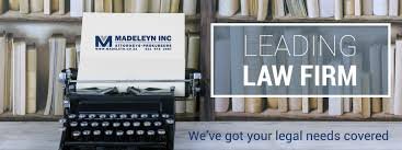 A Typewriter on a table with letterhead and promotional signage of Madeleyn Incorprated Attorneys in Langebaan.