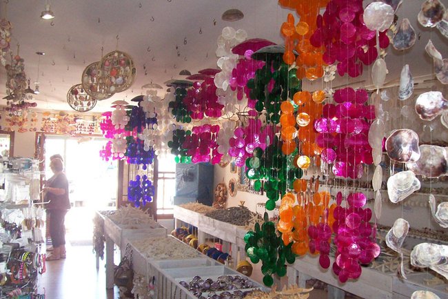 Sea Shells hanging in store at Neptune's Cave Shell Shop in Langebaan. Differnt colours from the ceiling to create shell chandeliers