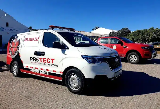 Two vans, one white and another red with signage for emergency responses by Protect Medical Response and Security Services in Langebaan.