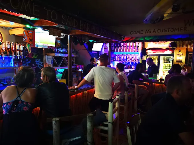 People sitting at bar counter at night at Pubs & Bars in Langebaan. This one is sandbar in Langebaan