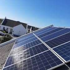 Solar panels attached to a roof of a home at an angle to capture sunlight and was installed by Langebaan Solar for residential properties.