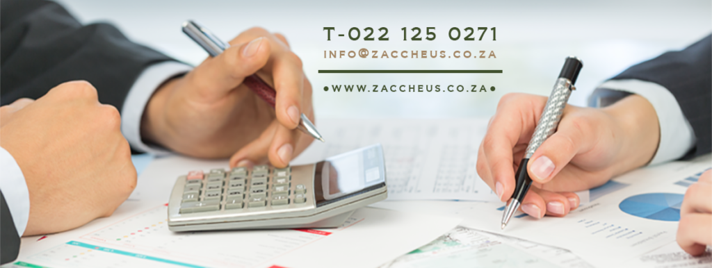 Two accountants at Zaccheus Accountants in Langebaan with pen in their hands and calculator , working through financial data.