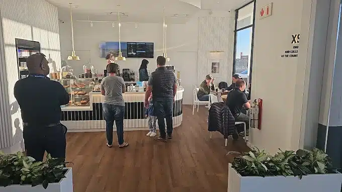 An interior picture of Bootlegger Coffee Shop in Laguna Mall, Langebaan with seating area, serving desk and wooden floors.