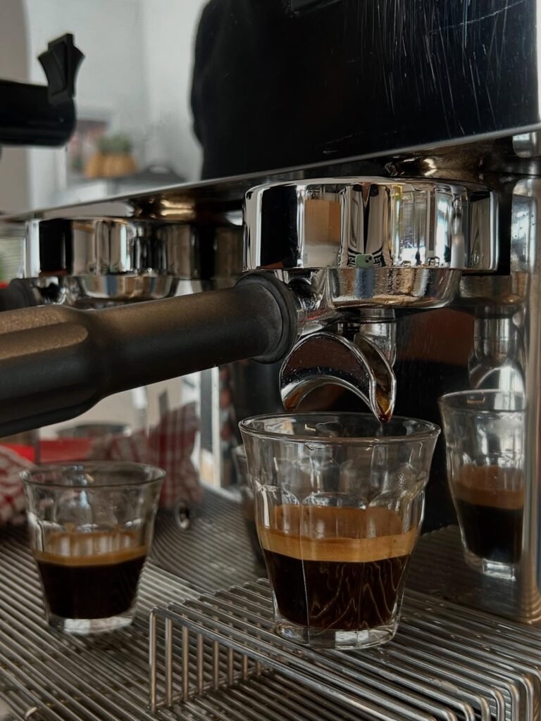 Fresh coffee from the coffee machine being pouredd into glass mugs at Cafe Gelato in Langebaan.