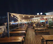 Evening with lights on the deck at Kapstadt Brauhaus to enjoy the best Sunset at Langebaan Restaurants