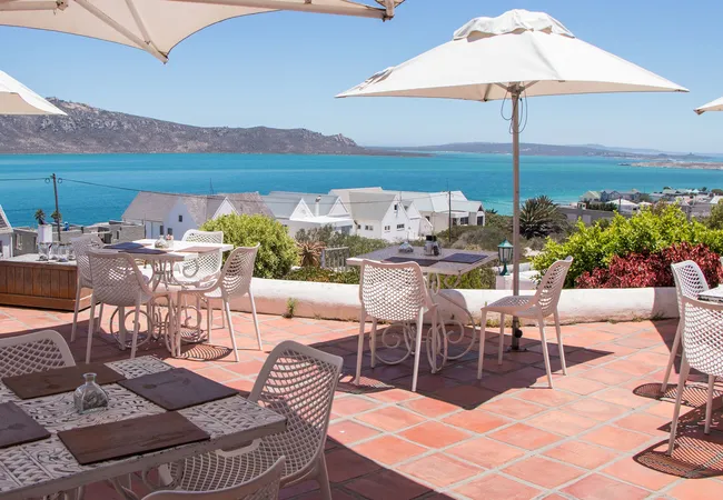 Outside deck of the La Petite Restaurant offering breathtaking views of the Langebaan Lagoon in a distance as one of the Fine dining Langebaan Restaurants