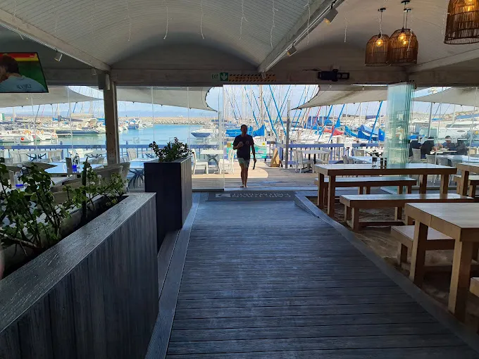 man walking towards restaurant at the Cape Fish Market. Marina provides Langebaan Restaurants with great views over the yachts