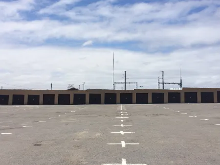 A Row of storage garages in a distance at Langebaan Storage for household goods, boats, cars and more with big paved area .