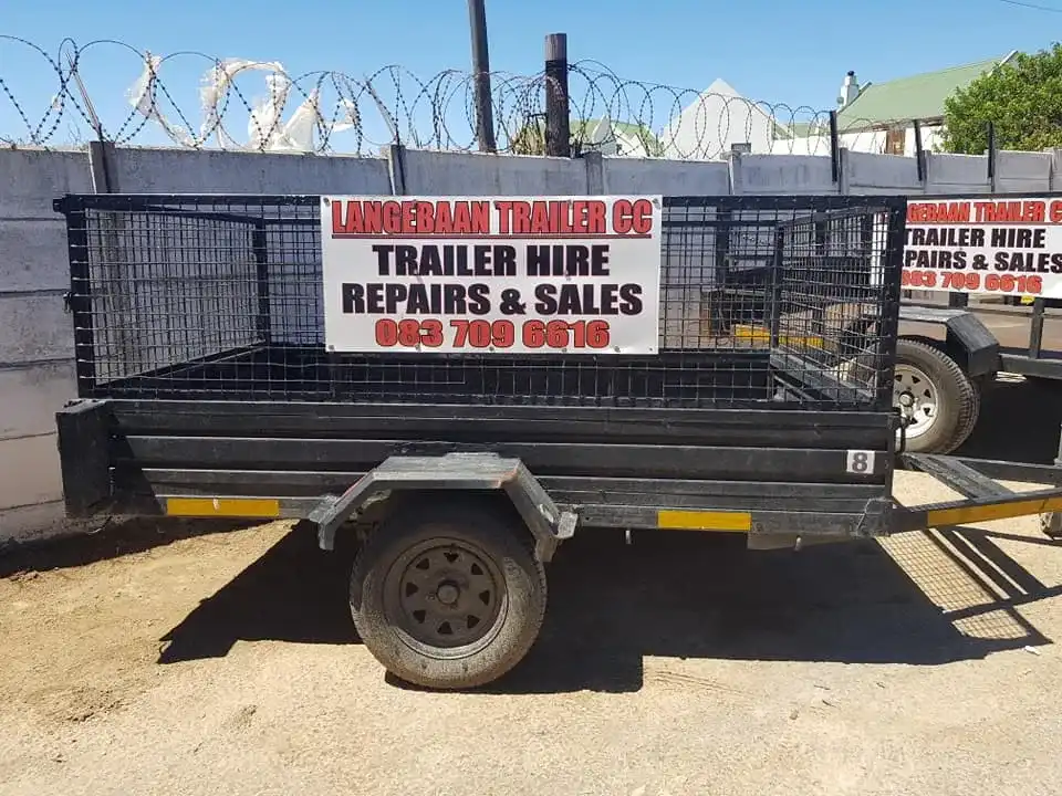 Picture of a A trailer for hire at Langebaan Trailer & Boatyard with sign on the side. Varies sizes available for rentals.