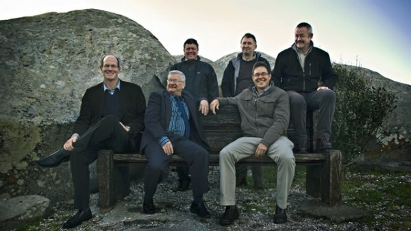 The Attorneys at P.P. Smit Attorneys in Langebaan sitting outside on a rocky surface in Langebaan.