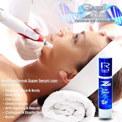 A lady receives treatment to her face with an instrument by a staff member at The room Aesthetics and Beauty Salon in Langebaan with blue product bottle on display.