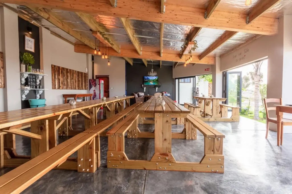 The length of The Table vnue for functions with wooden tables, seating and bulk heads and closed kitchen.