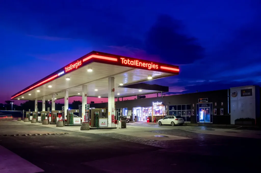 TotalEnergies Petrol station in Langebaan on Oostewal Street at night with red neon signage on canopy and convenience shop Bonjour in main building.